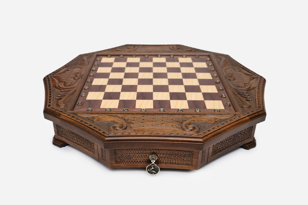 Empty octagonal honey-walnut chess board showing the carved acanthus corners and inlaid checkered surface
