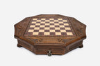 Empty octagonal honey-walnut chess board showing the carved acanthus corners and inlaid checkered surface