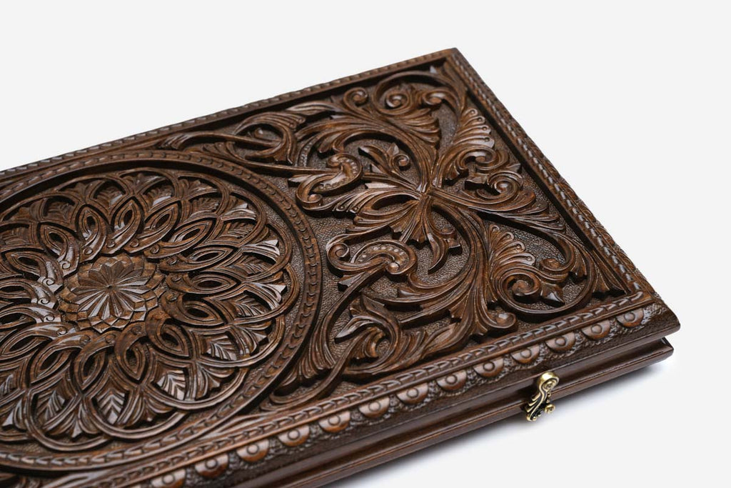 The carved board partly open, showing its hinged case form