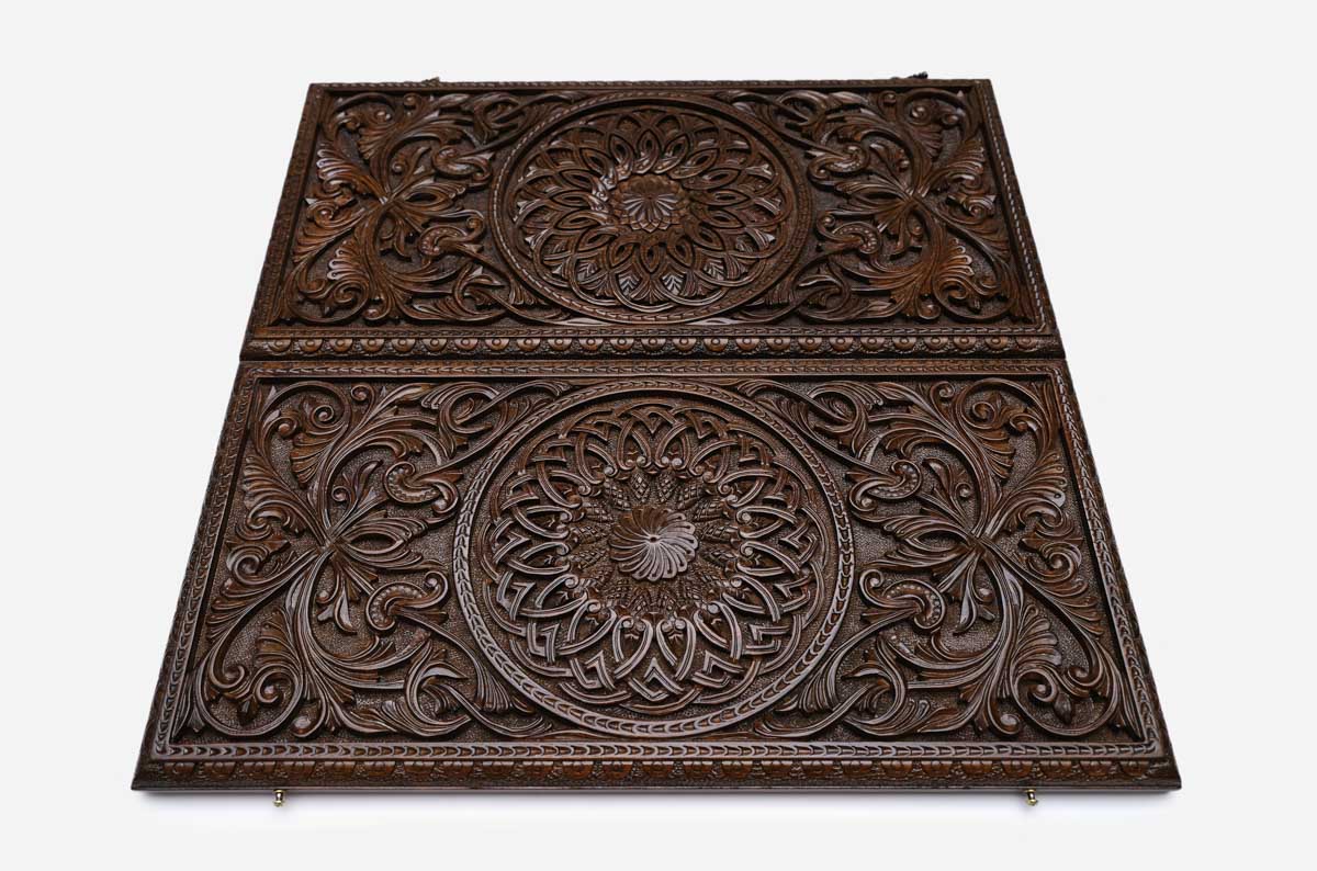 Side view of the closed carved case showing the depth of the relief