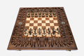 Luxury chess backgammon set opened with ornate bronze pieces set up, framed by a deeply carved border