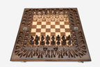 Angled view of the relief-carved chess set with its bronze figural pieces