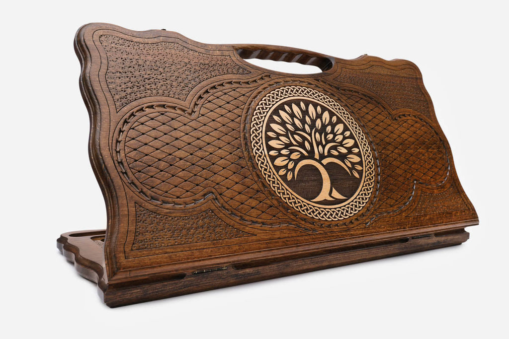 Carved Armenian backgammon board with the tree of life inside a ring of interlace and a cut-out carry handle, propped open