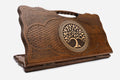 Carved Armenian backgammon board with the tree of life inside a ring of interlace and a cut-out carry handle, propped open