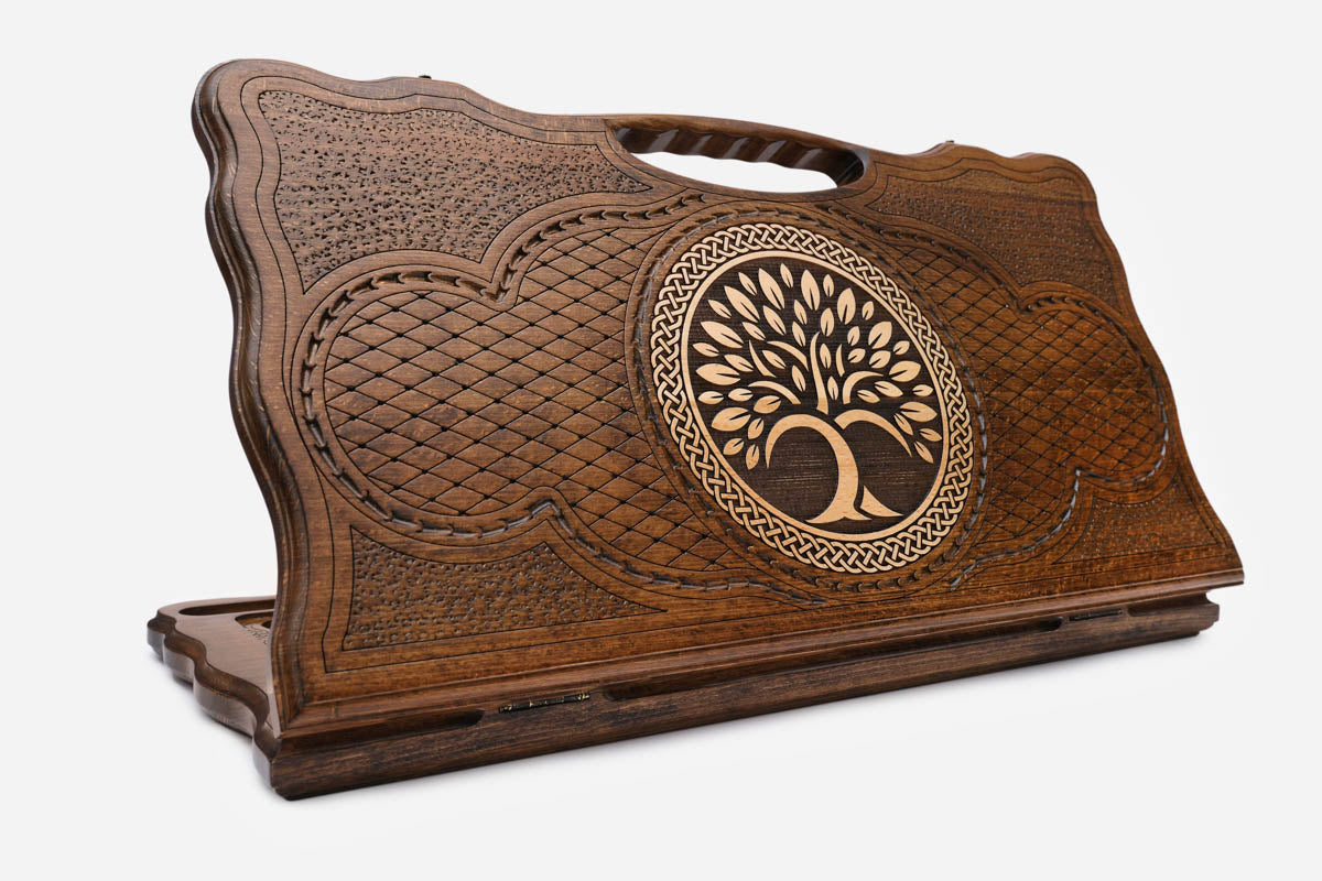 Carved Armenian backgammon board with the tree of life inside a ring of interlace and a cut-out carry handle, propped open