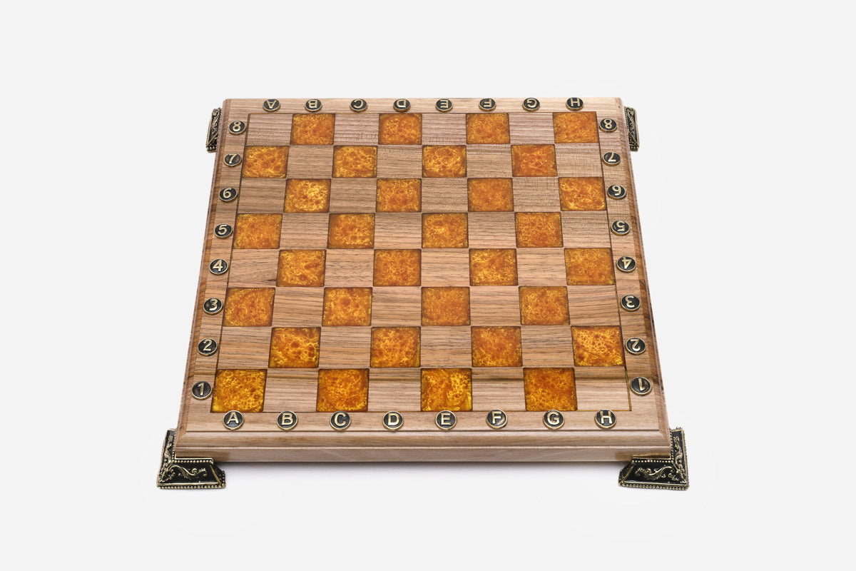 Angled view of the orange epoxy chess set with its bronze figural pieces