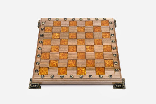 Empty chess board with amber epoxy squares, round brass coordinate discs and cast brass feet, from above