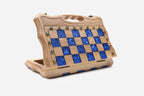 Angled view of the blue epoxy chess set with its bronze figural pieces
