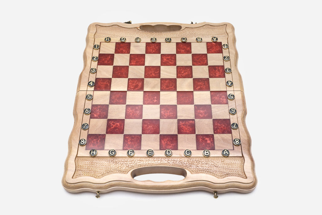 Overhead view of the red epoxy board with the full set of wooden pieces