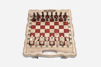 Compact folding chess board in pale wood with red epoxy squares and wooden pieces set up for play