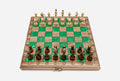 Compact folding walnut chess board with green epoxy squares and wooden pieces set up for play