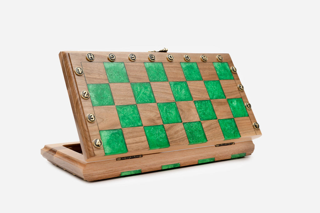 The compact green epoxy chess set shown from an angle