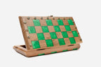The compact green epoxy chess set shown from an angle