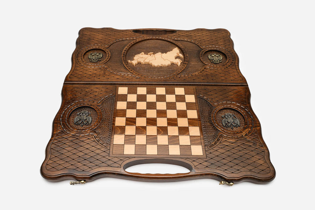 Angled view of the luxury Russian backgammon set showing the carved map and bronze details