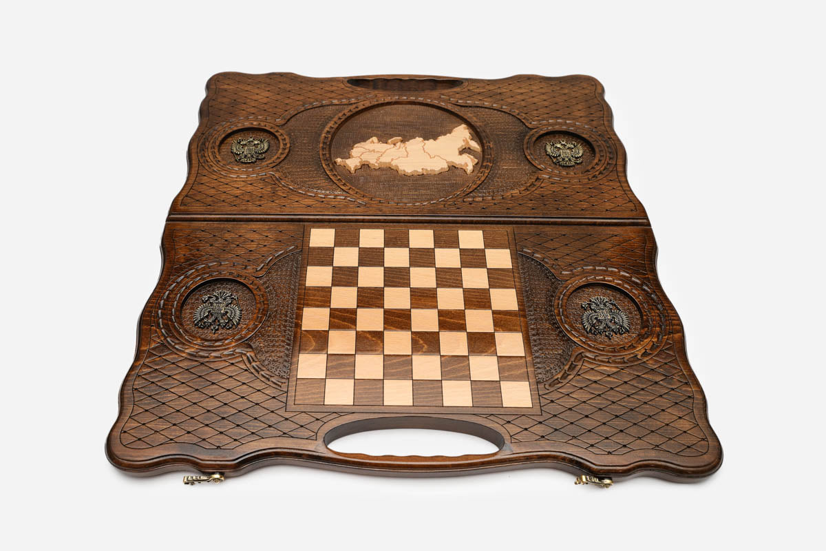 Angled view of the luxury Russian backgammon set showing the carved map and bronze details