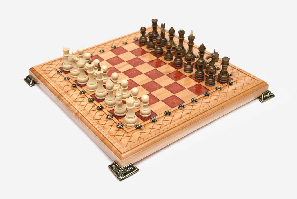 Close-up of the beech and walnut chess pieces on the red epoxy squares