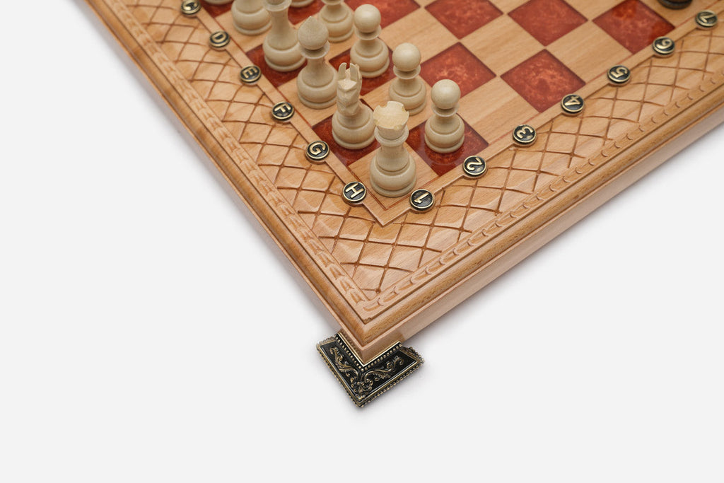 Close-up of an ornate brass corner bracket on the board