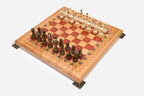 Angled view of the red epoxy chess set with its wooden pieces