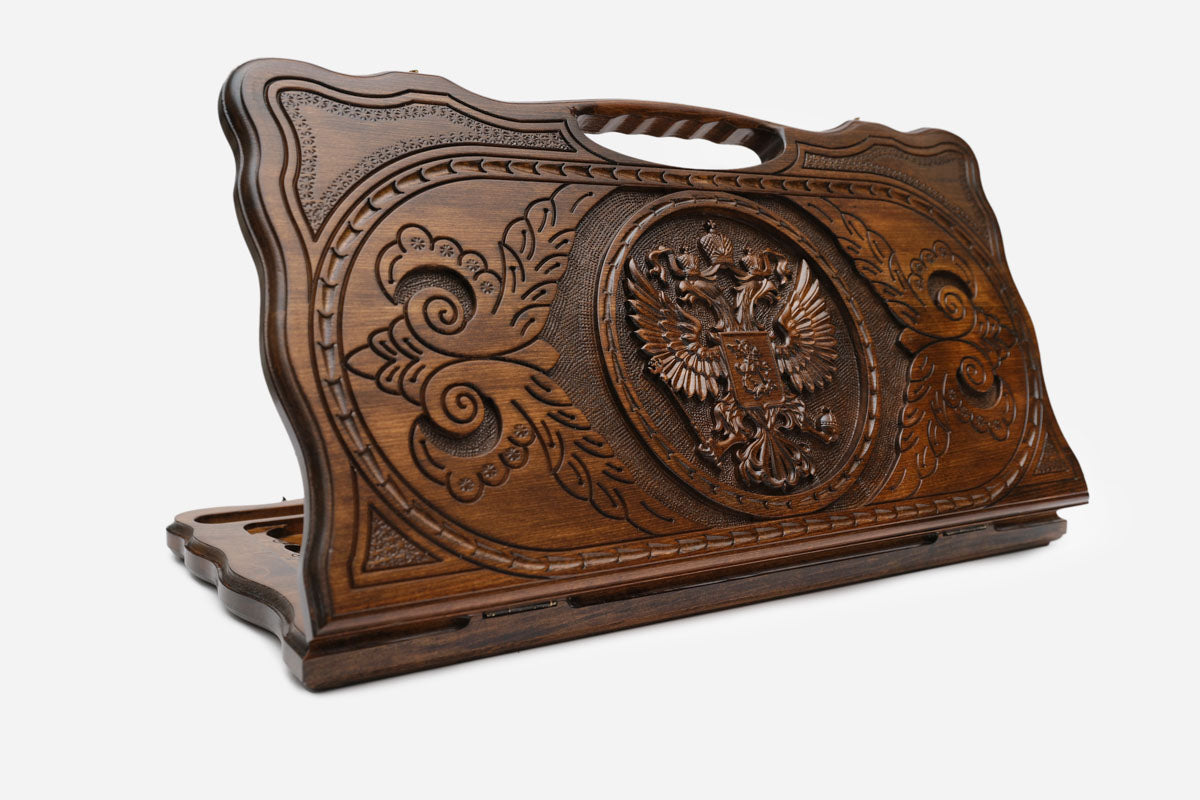 Carved Russian backgammon board with the double-headed eagle and a cut-out carry handle, propped open