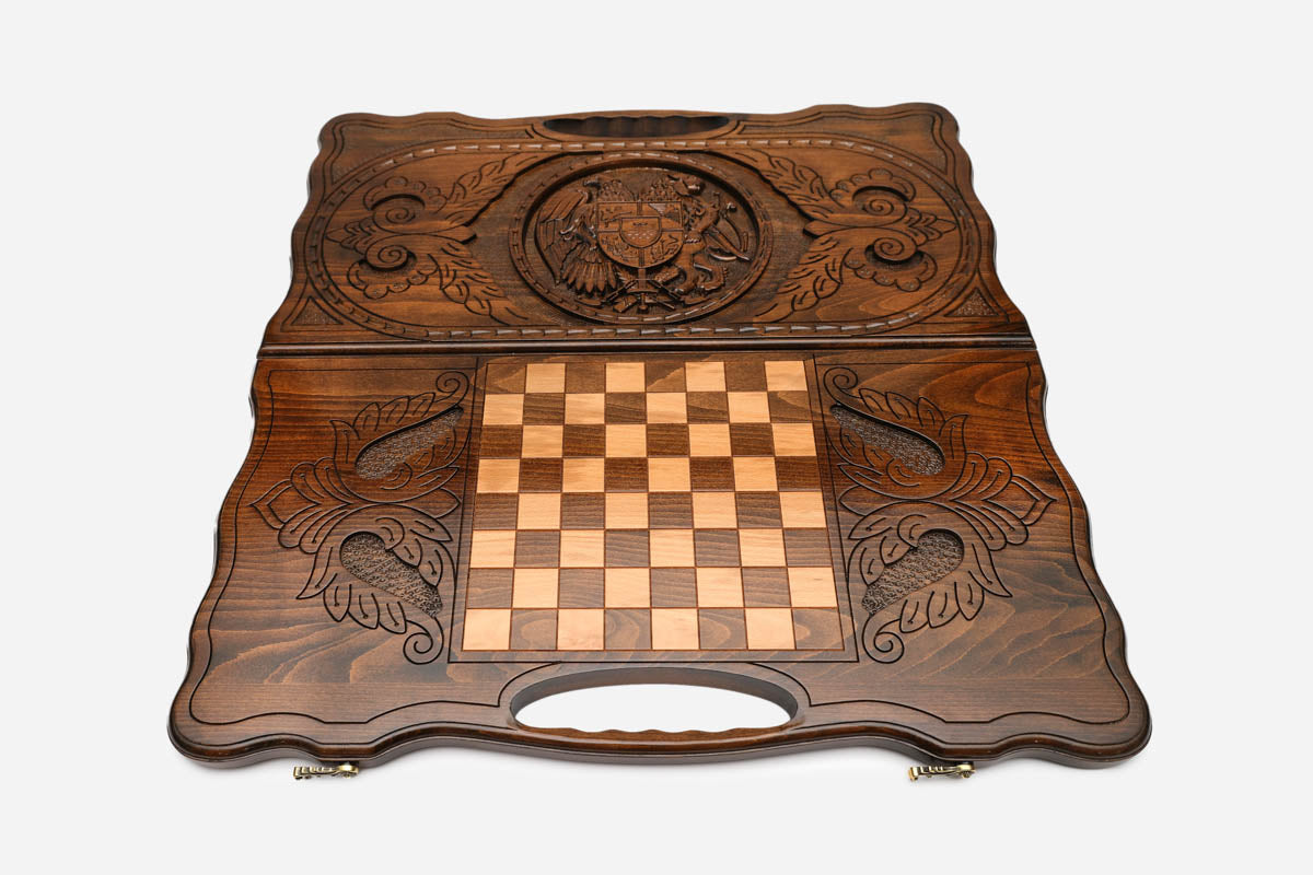 Angled view of the handmade Armenian backgammon set showing the carved emblem