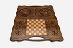 Angled view of the handmade backgammon set showing both carved emblems on the lid