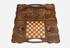 Angled view of the luxury handmade backgammon set showing the carved forest scene