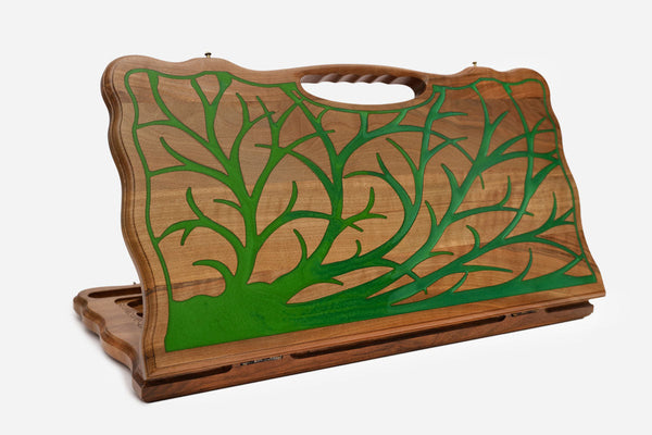 Walnut backgammon board with a green epoxy tree of life and a cut-out carry handle, standing upright