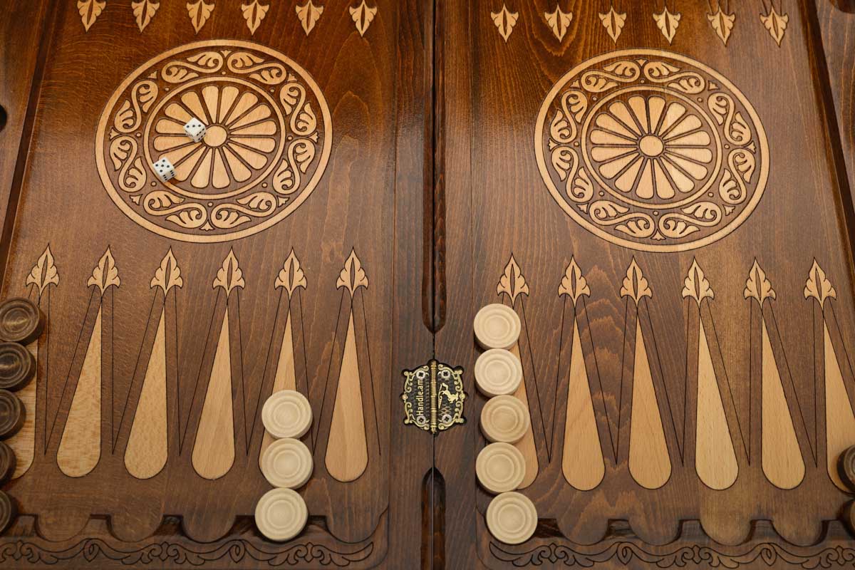 Close-up of the checkers, dice and cup on the eagle backgammon table