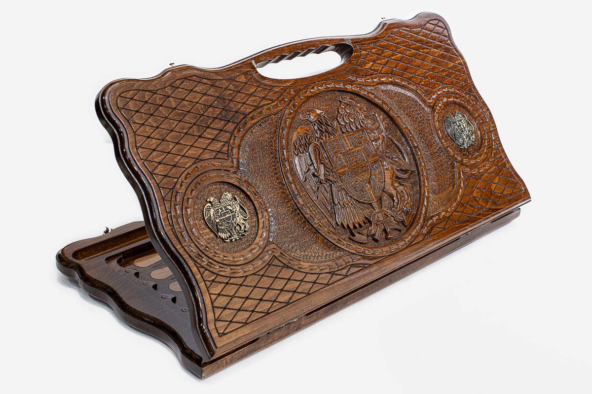 Carved beechwood backgammon board with the Armenian coat of arms and bronze roundels, propped open