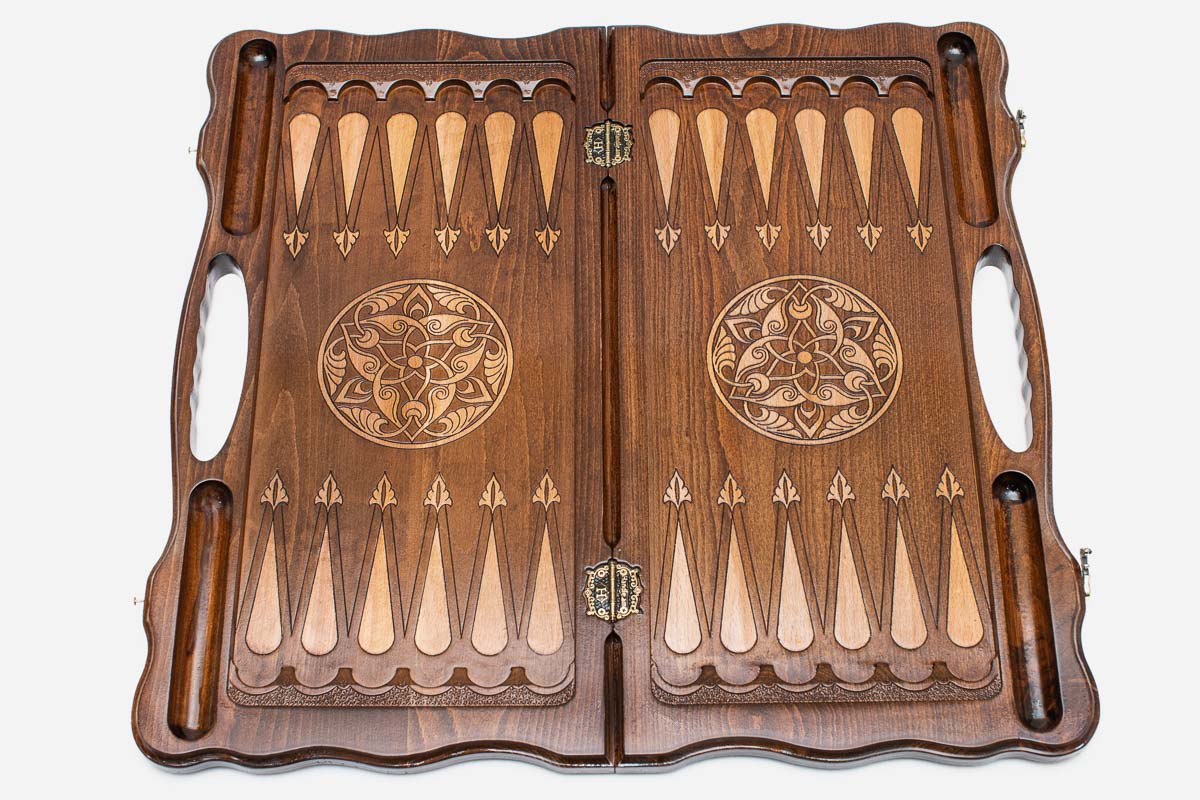 The backgammon board opened to show the wooden playing surface