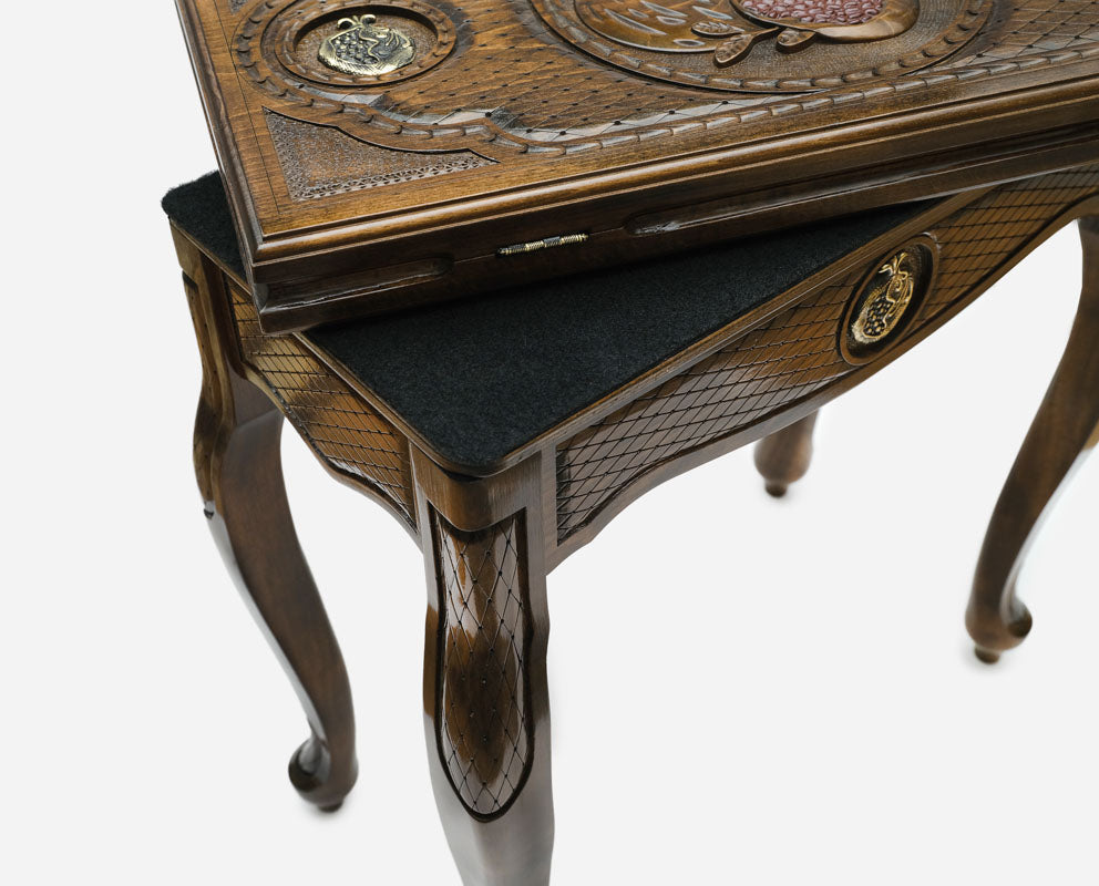 Close-up of the bronze pomegranate at the centre of the backgammon table lid