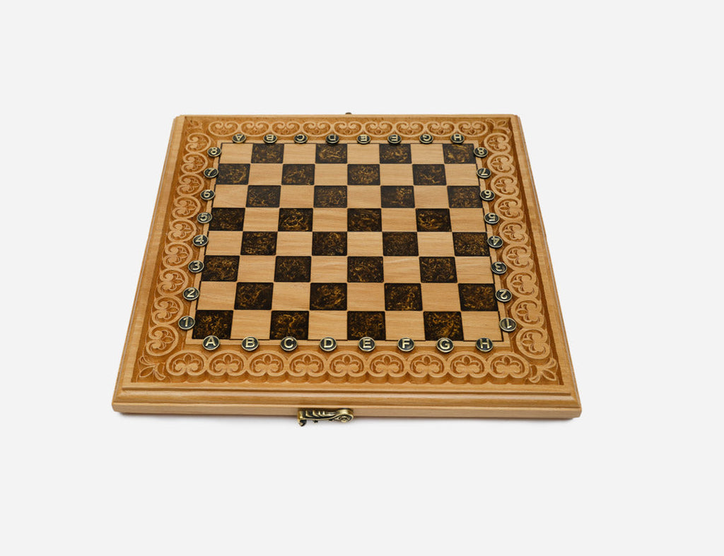 The empty brown epoxy chess board showing its carved arch border and bronze clasp