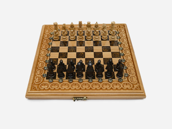 Luxury brown epoxy chess set with figural carved pieces set up for play on its arch-bordered board