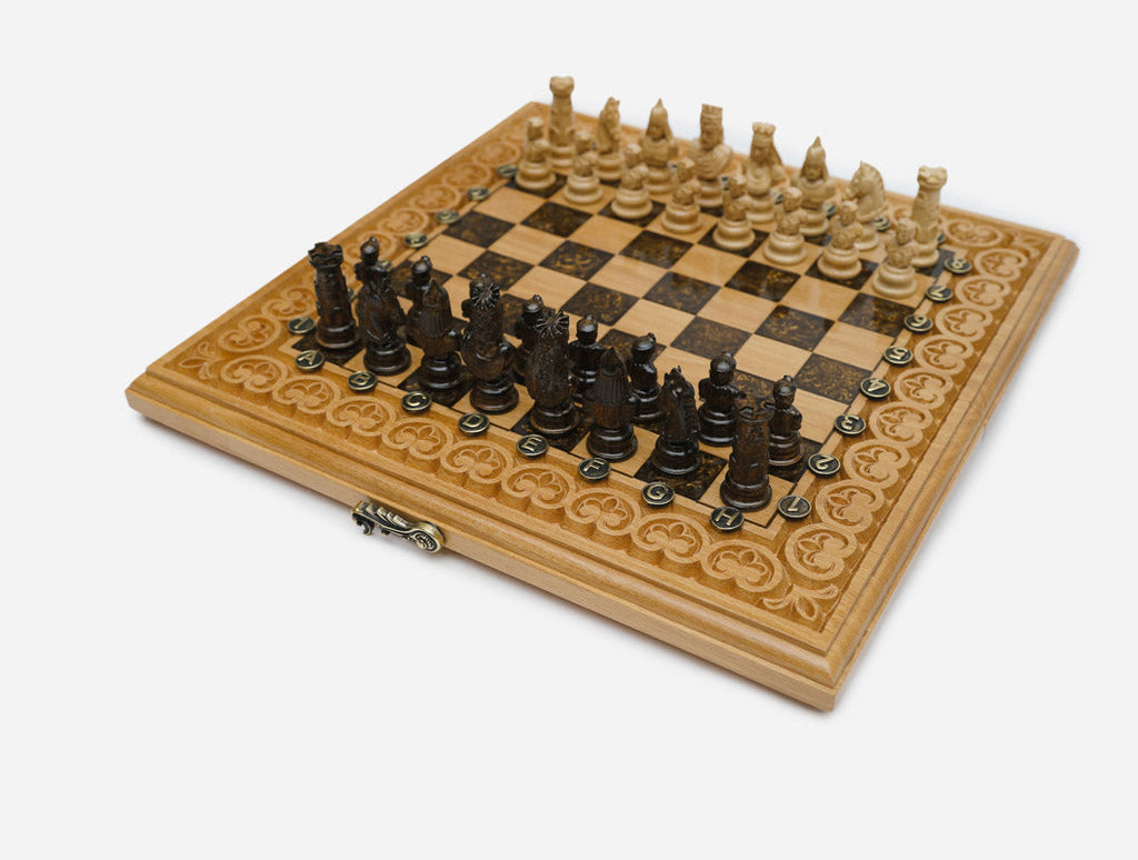 Overhead view of the folding chess board with the full set of 32 figural pieces