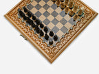 Detail of the figural chess pieces standing on the marbled brown epoxy squares