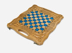 The folding board partly closed, showing the carved case