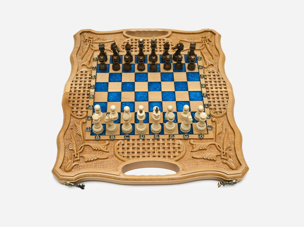 Luxury blue epoxy chess set with royal-blue squares, carved borders and turned wooden pieces set up for play