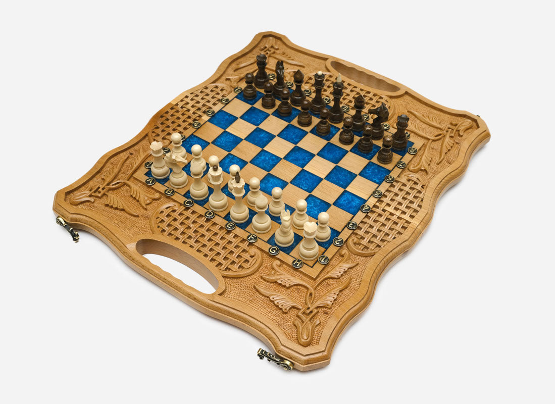 Overhead view of the full set of light and dark wooden pieces on the blue epoxy board