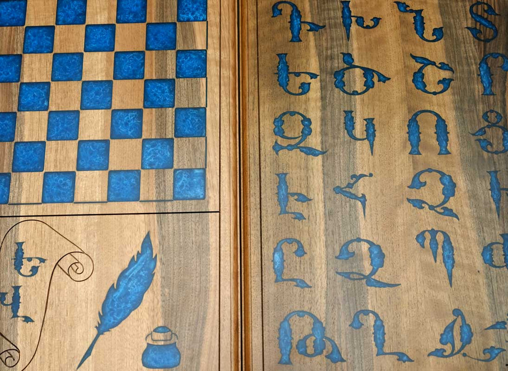 Close-up of the blue epoxy Armenian letters set into the walnut