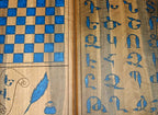 Close-up of the blue epoxy Armenian letters set into the walnut