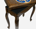 Side view of the handmade chess table on its four carved cabriole legs