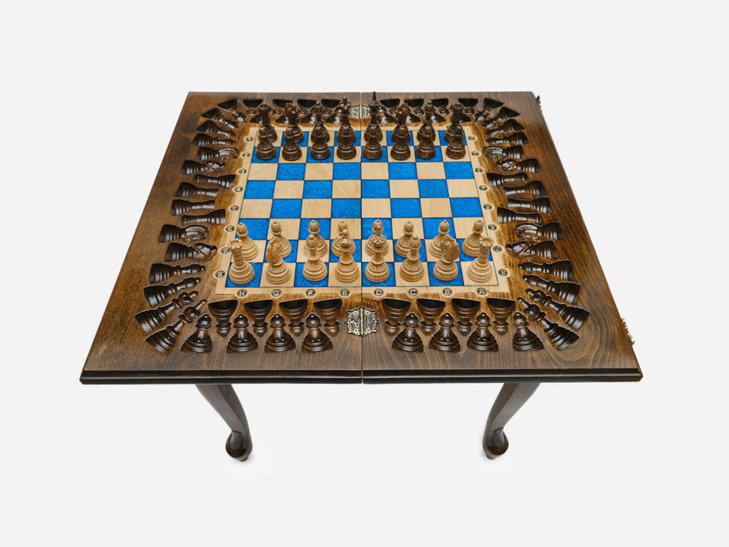 Close-up of the turned wooden chess pieces standing on the blue epoxy squares