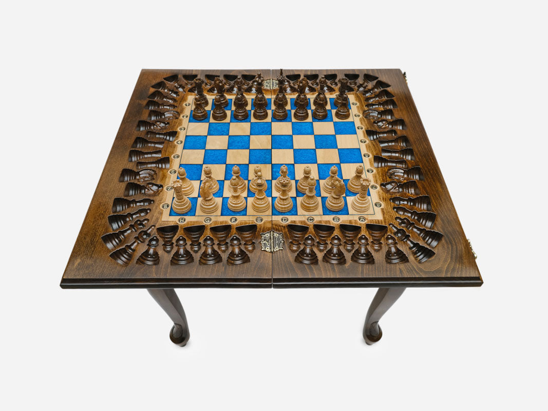 Close-up of the turned wooden chess pieces standing on the blue epoxy squares