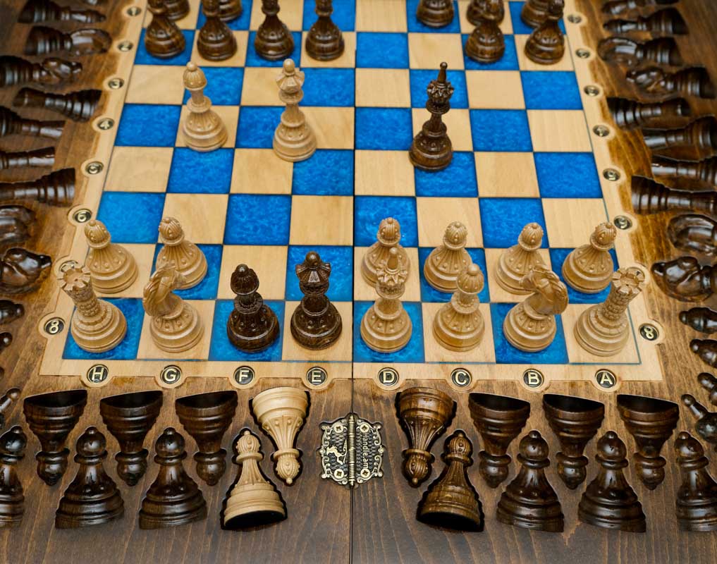 Overhead view of the blue epoxy playing field and its beech and walnut chess pieces