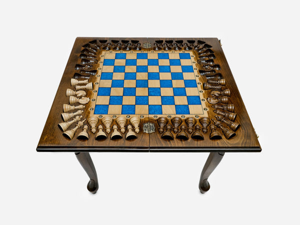 Luxury epoxy chess table with a blue epoxy board and turned wooden pieces around the border, on carved cabriole legs