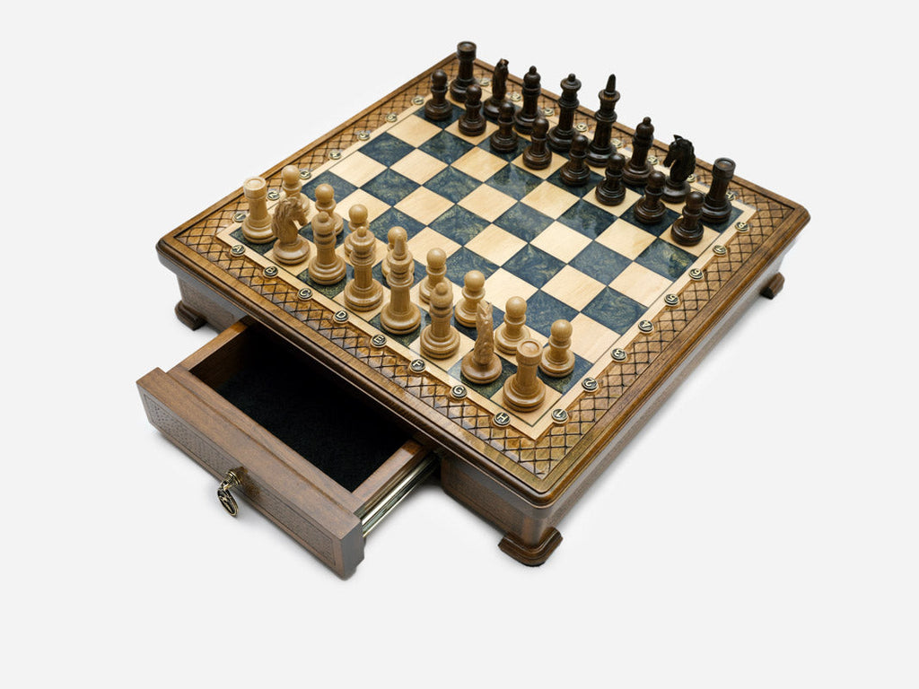 Gray epoxy chess set with pieces set up and drawer open, angled view