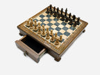 Gray epoxy chess set with pieces set up and drawer open, angled view
