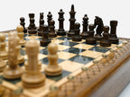 Close-up of the wood chess pieces on the gray epoxy board