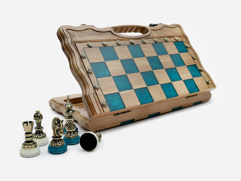 Angled view of the folding turquoise epoxy chess board with its bronze army set up