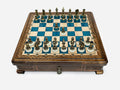 Blue epoxy chess set with bronze pieces set up for play, front view